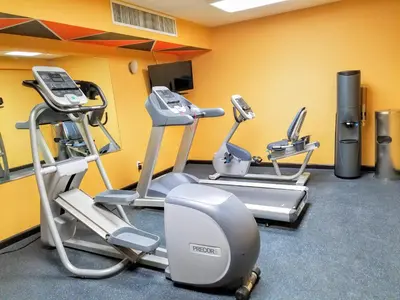 a gym with cardio equipment in a room at Days Inn by Wyndham Windsor Locks / Bradley Intl Airport in Windsor Locks