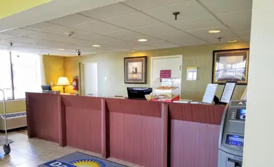 a waiting area of a waiting room with a counter at Days Inn by Wyndham Windsor Locks / Bradley Intl Airport in Windsor Locks