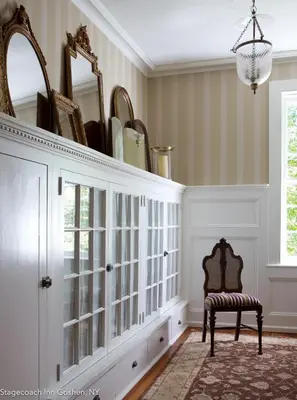 a room with a hutch with a chair and a mirror at Stagecoach Inn in Goshen