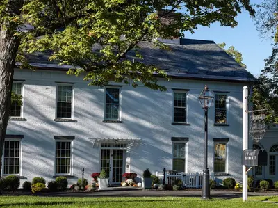 a white house with a street light in front of it at Stagecoach Inn in Goshen
