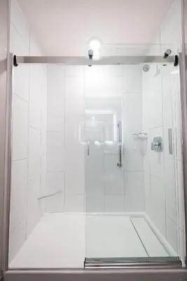 a shower with a glass door in a bathroom at Hilton Scranton & Conference Center in Scranton