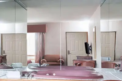 a bathroom with a purple sink and a mirror at Howard Johnson by Wyndham Lenox in Lenox