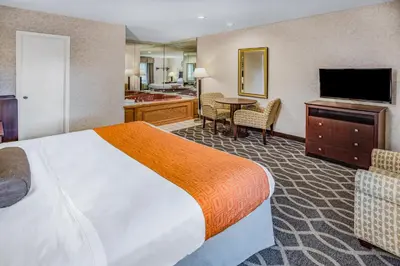 a hotel room with a bed and a bathroom at Howard Johnson by Wyndham Lenox in Lenox
