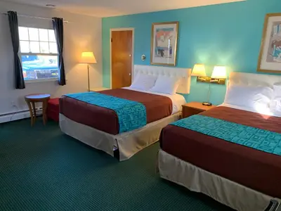 a hotel room with two beds and a window at Howard Johnson by Wyndham Williamstown in Williamstown