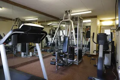 a gym with a bunch of equipment in it at TraveIodge by Wyndham Parsippany in Parsippany