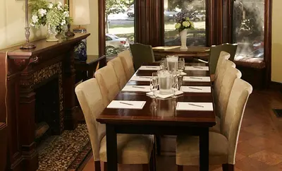 a dining room with a wooden table and chairs at Morgan State House Inn in Albany