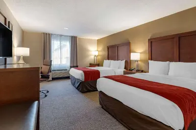 a hotel room with two beds and a flat screen tv at Comfort Inn Glenmont - Albany South in Glenmont