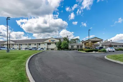 an empty road in front of a large building at Comfort Inn Glenmont - Albany South in Glenmont