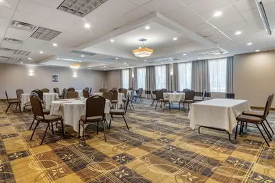 a banquet room with tables and chairs in a room at Comfort Inn Glenmont - Albany South in Glenmont