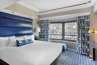 a hotel room with a large bed and a window at Hilton Club New York in New York