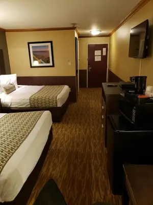 a hotel room with two beds and a television at Baymont by Wyndham Pompton Plains/Wayne in Pompton Plains