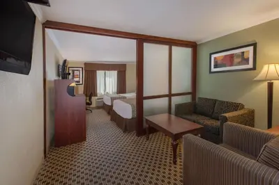 a hotel room with a couch and a living room at Baymont by Wyndham Pompton Plains/Wayne in Pompton Plains