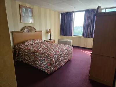 a hotel room with a bed and a window at Amsterdam Hotel in Stamford
