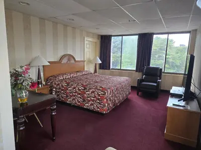 a hotel room with a bed and a desk and a chair at Amsterdam Hotel in Stamford