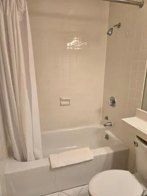 a bathroom with a white tub and a toilet at Amsterdam Hotel in Stamford