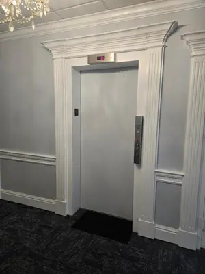a white door with a clock on top of it at Amsterdam Hotel in Stamford