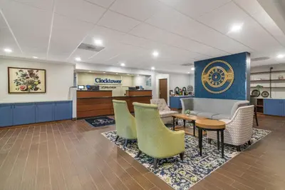 a waiting area of a hospital with chairs and a table at The Clocktower Hotel Latham - North Albany, an Ascend Collection Hotel in Cohoes
