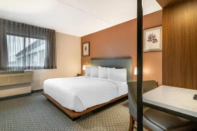 a hotel room with a bed and a window at The Clocktower Hotel Latham - North Albany, an Ascend Collection Hotel in Cohoes