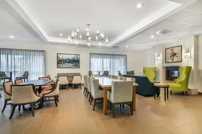 a dining room with a table and chairs at The Clocktower Hotel Latham - North Albany, an Ascend Collection Hotel in Cohoes