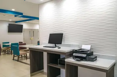an office with a desk with a computer on it at La Quinta by Wyndham Latham Albany Airport in Latham