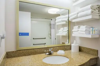 a bathroom with a sink and a mirror at Hampton Inn Clifton Park in Clifton Park