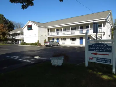 a building with a car parked in a parking lot at Super 8 by Wyndham Albany in Albany