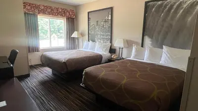 a hotel room with two beds and a window at Super 8 by Wyndham Albany in Albany