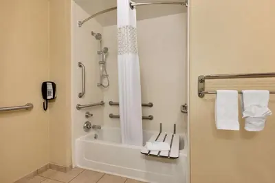a bathroom with a tub and a shower with towels at Hampton Inn & Suites Mahwah in Mahwah