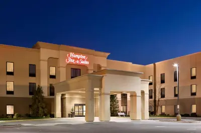 a hotel with a sign on the front of a building at Hampton Inn & Suites Mahwah in Mahwah