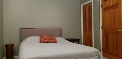 a bed with a red pillow on top of it at Hunter Mt Amazing Views Catskills! 5 Bedrooms! Best Choice! in Hunter
