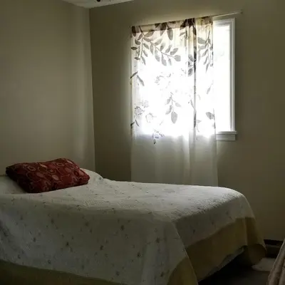 a bedroom with a bed and a window with a curtain at Hunter Mt Amazing Views Catskills! 5 Bedrooms! Best Choice! in Hunter