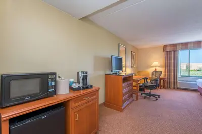 a hotel room with a television and a desk with a computer at Hilton Garden Inn Fishkill in Fishkill