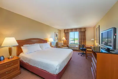 a hotel room with a bed and a flat screen tv at Hilton Garden Inn Fishkill in Fishkill