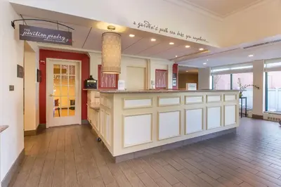 a large lobby with a counter in a building at Hilton Garden Inn Fishkill in Fishkill