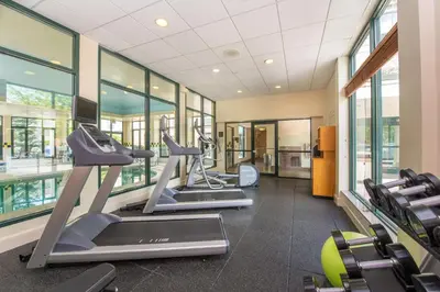 a gym with treadmills and elliptical machines at Hilton Garden Inn Fishkill in Fishkill
