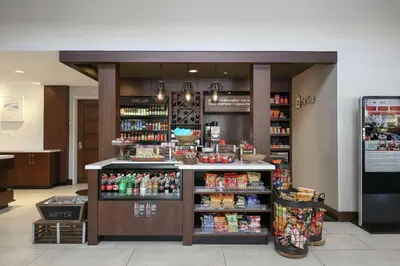 a grocery store with a counter in a store at Hilton Garden Inn Melville in Plainview