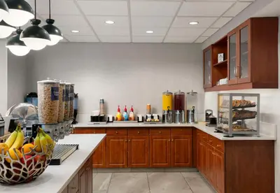 a large kitchen with wooden cabinets and a counter top at Homewood Suites by Hilton Hartford South-Glastonbury in Glastonbury