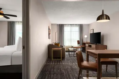 a hotel room with a bed and a dining room at Homewood Suites by Hilton Hartford South-Glastonbury in Glastonbury