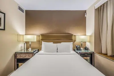 a bedroom with a large bed with two night stands at The Historic Blue Angel Hotel Lexington Ave, an Ascend Collection in New York