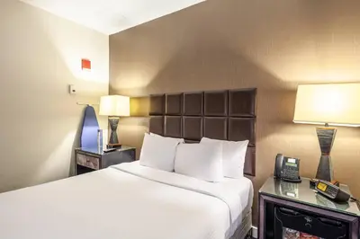 a hotel room with a bed and a telephone at The Historic Blue Angel Hotel Lexington Ave, an Ascend Collection in New York