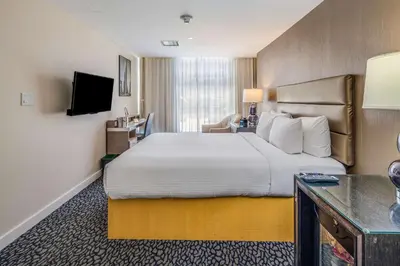 a hotel room with a large bed and a television at The Historic Blue Angel Hotel Lexington Ave, an Ascend Collection in New York