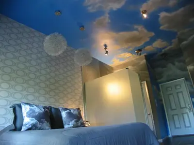 a bedroom with a bed with lights on the ceiling at The Roxbury in Roxbury