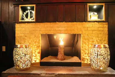 a brick fireplace with a candle in it at The Roxbury in Roxbury