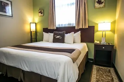 a hotel room with a large bed with a window at Pointe Plaza Hotel in Brooklyn