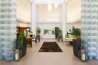 a lobby of a hotel with potted plants at Hilton Garden Inn Nanuet in Nanuet
