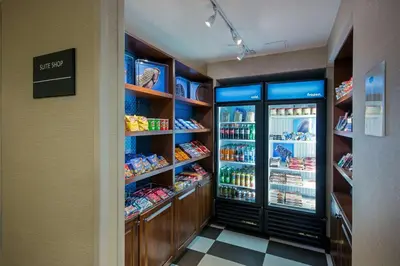 a grocery store aisle with a refrigerator and food at Hampton Inn West Springfield in West Springfield