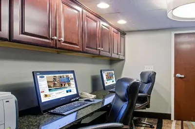 an office with a desk with a computer and chairs at Hampton Inn West Springfield in West Springfield