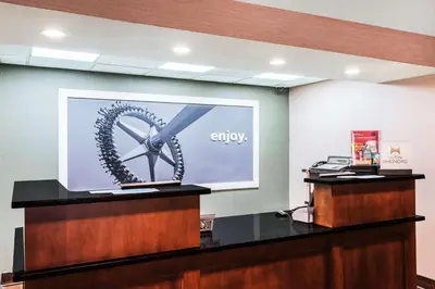 a projection screen with a wheel on a wall at Hampton Inn West Springfield in West Springfield