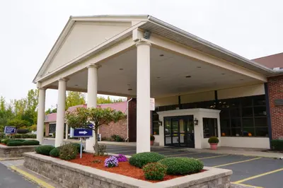 a front view of a building with columns at Rodeway Inn & Suites East Windsor in East Windsor