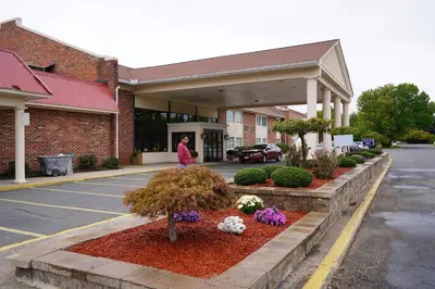 a woman walking in front of a building at Rodeway Inn & Suites East Windsor in East Windsor